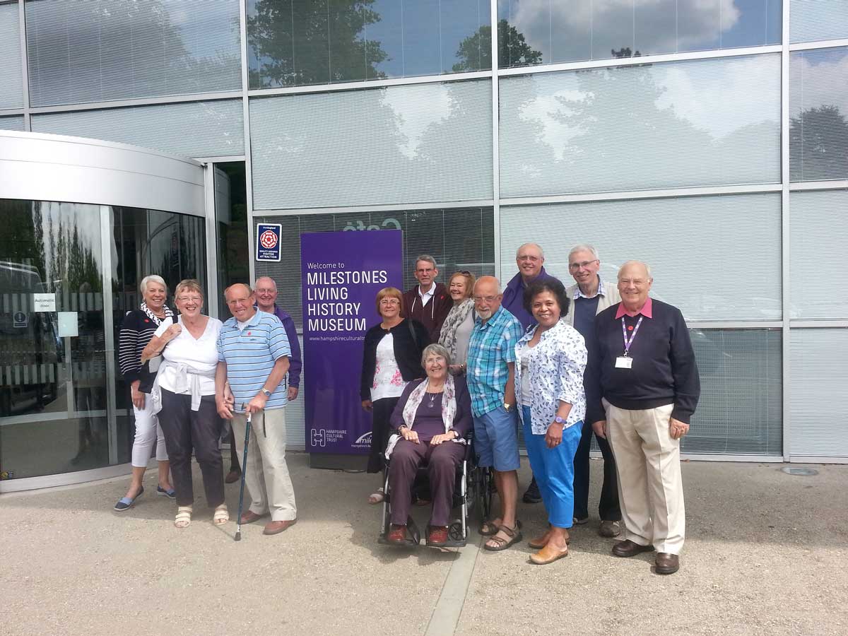 Several people standing together outside the Milestones Living History Museum.