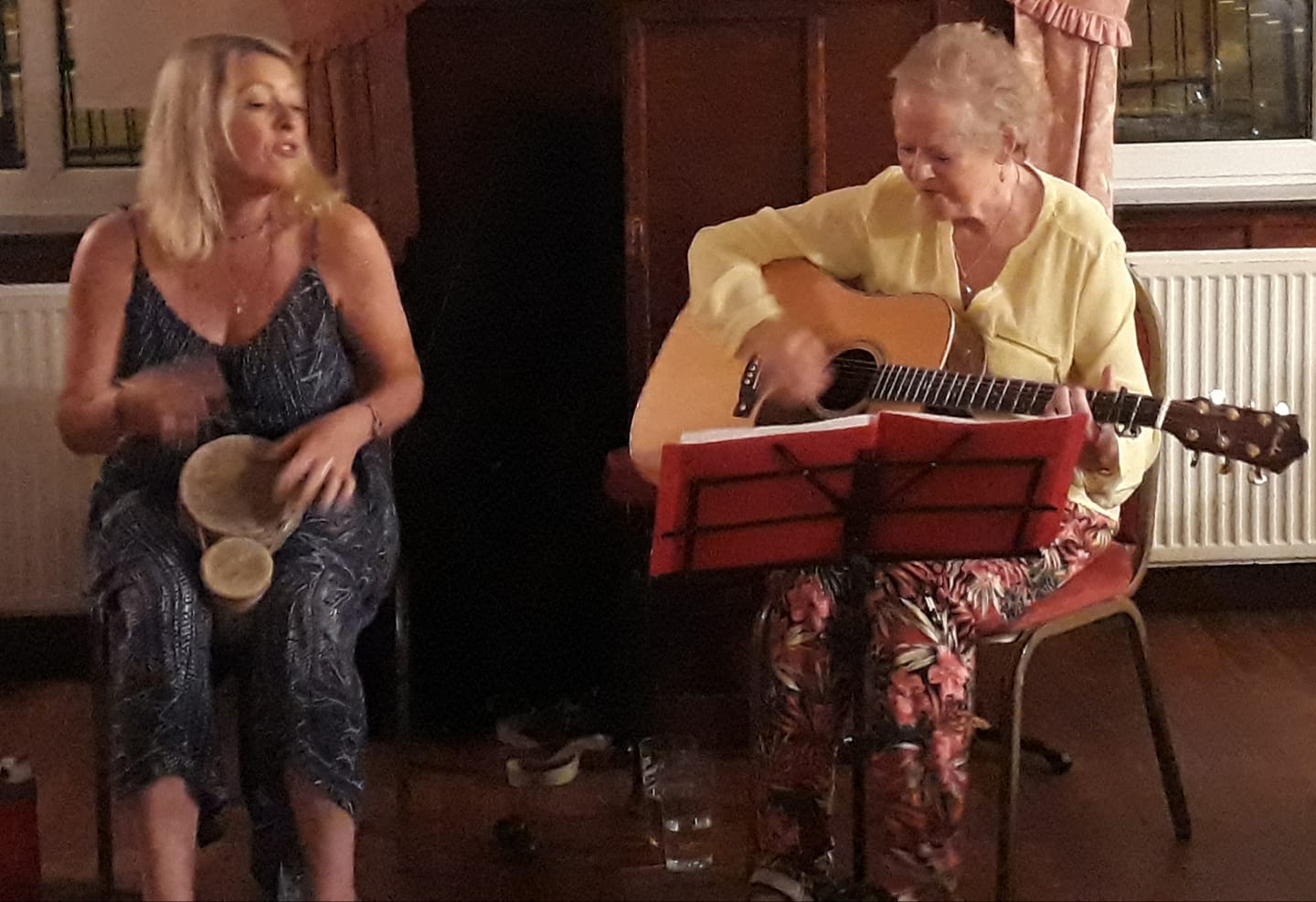 Shelly and Ann performing with musical instruments.